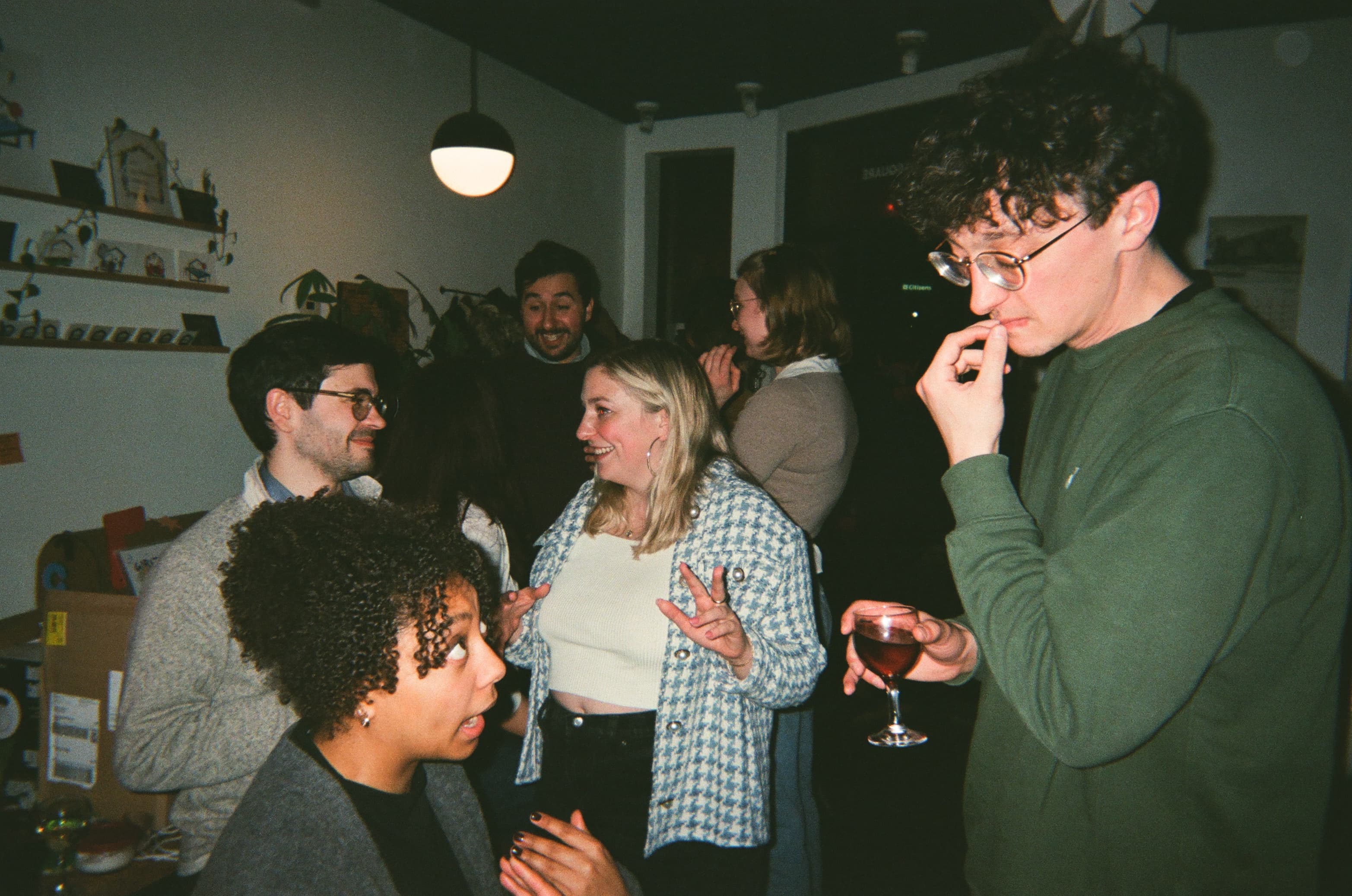 Members of Colère Nu in conversation at a private gathering
